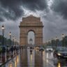 Delhi-NCR Weather Update 2026 showing heavy rain near India Gate with people and vehicles during thunderstorm